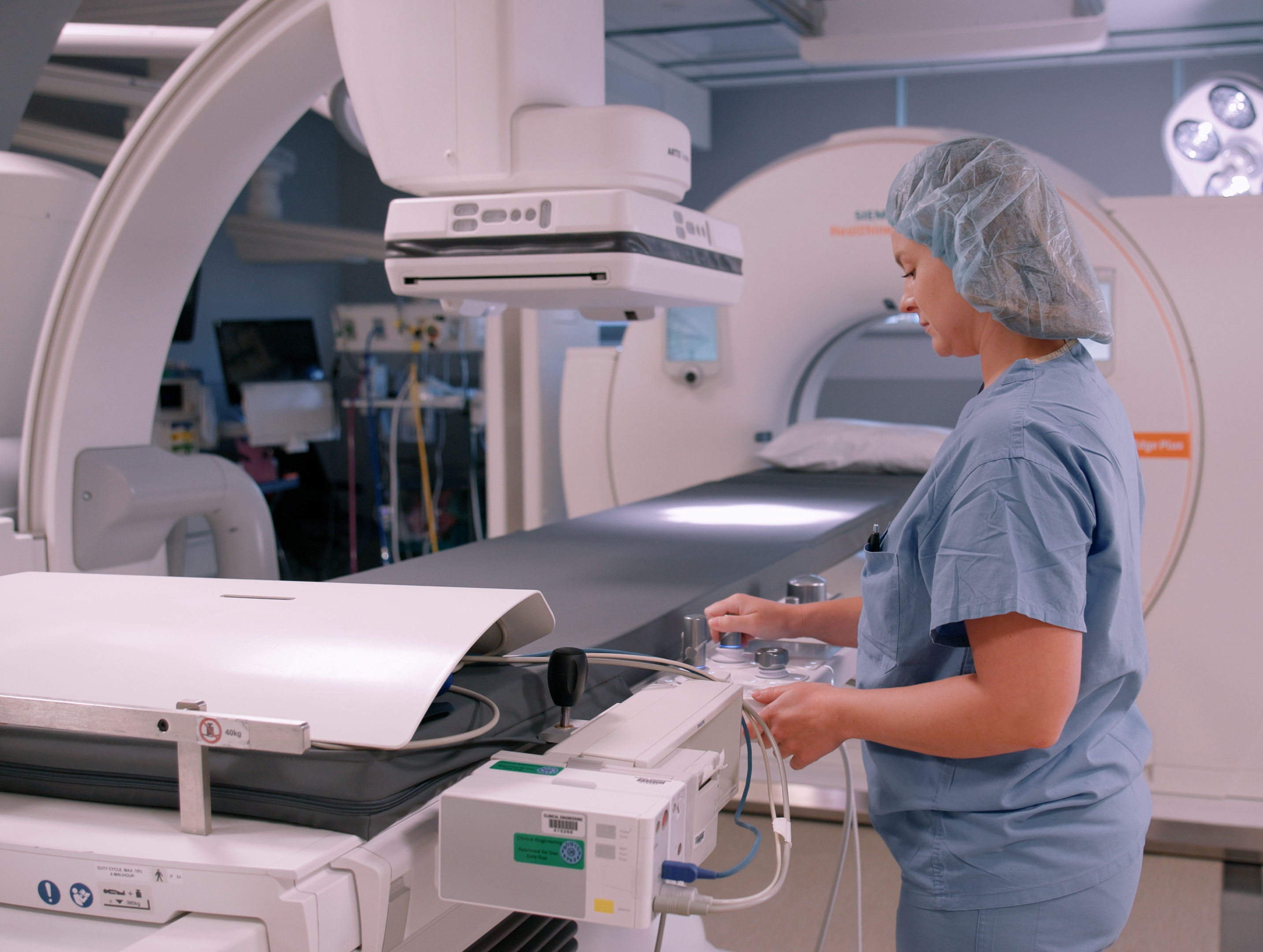 Staff member adjusts new operating table.jpg