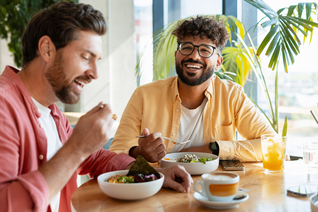 Happy friends eating healthy food at a restaurant.jpg