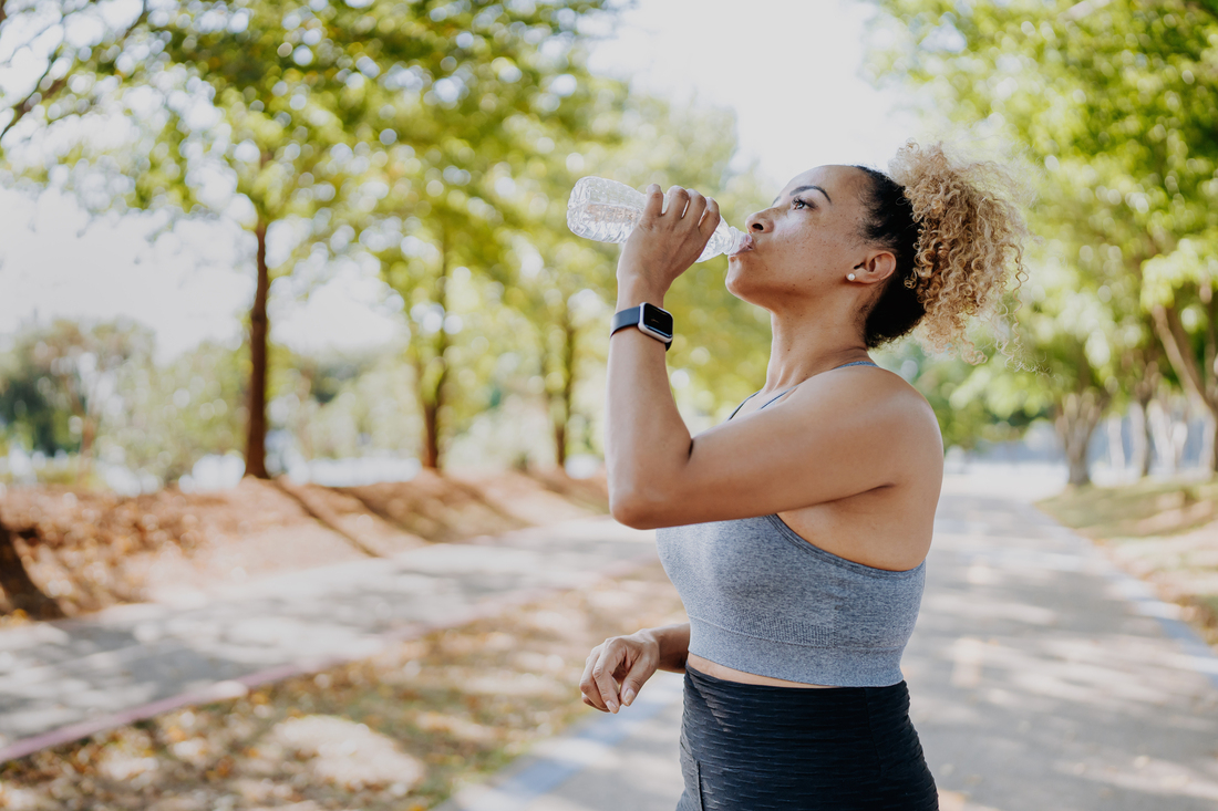 Woman drinking water from bottle.jpg