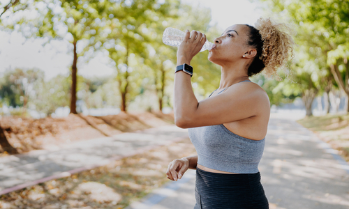 Woman drinking water from bottle.jpg