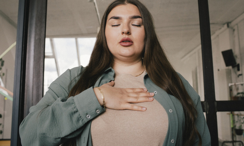 Woman taking deep breath with eyes closed.jpg